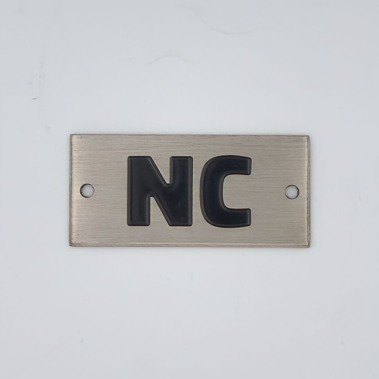 ± Badge Lid NC